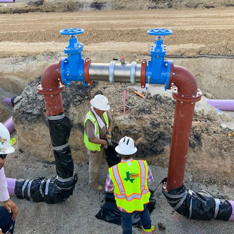 people working on a valve system